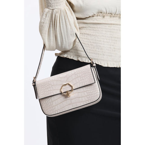 Woman with a trendy white bag for work with black trim and gold clasp.