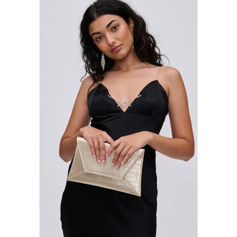 Woman in black dress, holds gold Valentine’s purse