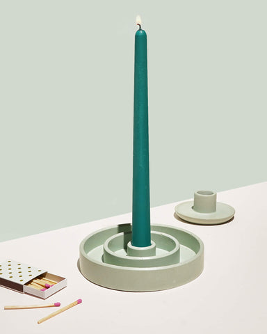 Green taper candle with a light green candle holder