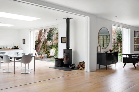 Open concept living room with a large circular mirror