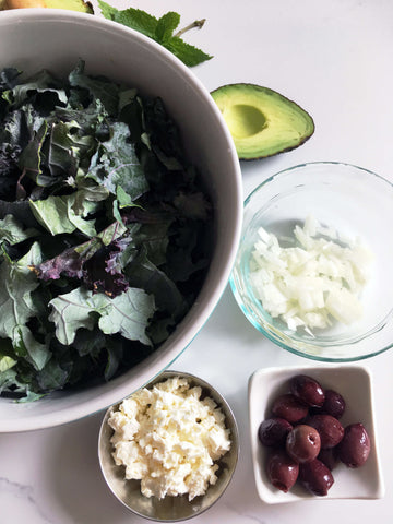 prepped ingredients: feta cheese, olives, avocado, onion and kale