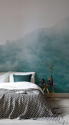 luxurious bed with a forest mural on the wall