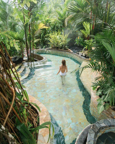 woman swimming in a hot pool in the jungle