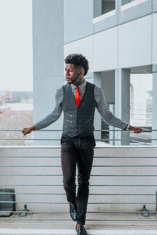 black man with burst fade standing outside