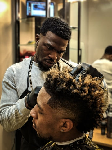 black man with mohawk fade at barbershop