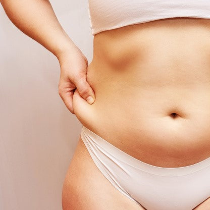 Unknown lady pinching belly fat at the abdomen - How to Lose Belly Fat Fast to Achieve Slim Belly - BeautyFoo Mall Malaysia