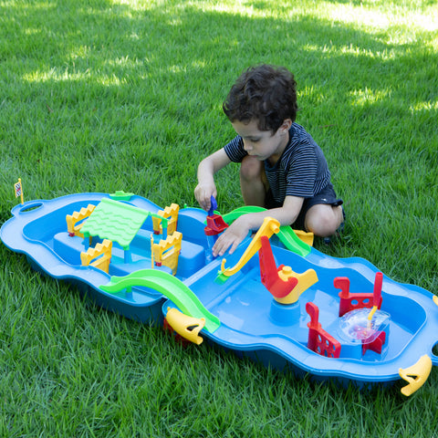 Child playing with fun water trolley