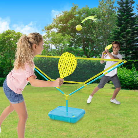 Two children playing tennis game in garden