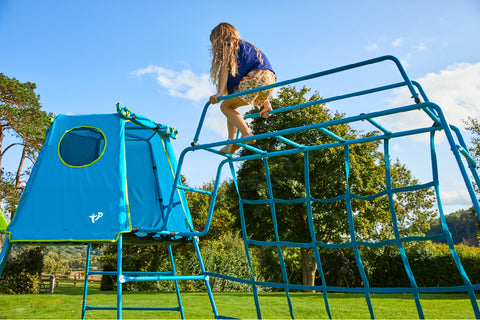 Child playing on metal climbing frame