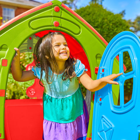 A child playing in a plastic kids playhouse
