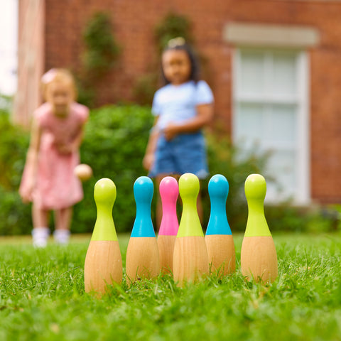 Two children playing with garden skittles game