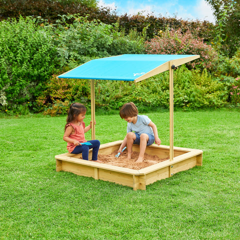 Two children in sand pit with canopy