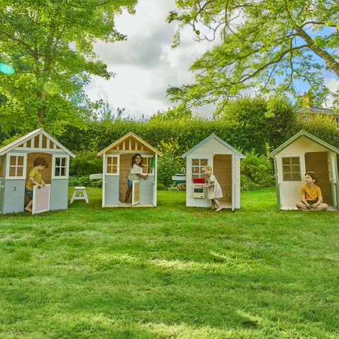 Children playing in wooden single storey playhouses