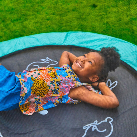 Child playing on trampoline