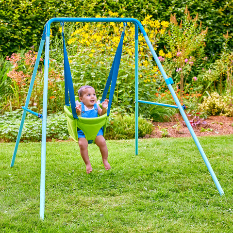 Baby swinging in toddler metal swing set