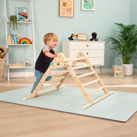 Child climbing on Montessori Pikler Triangle