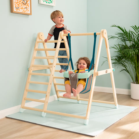 Toddlers playing on a toddler wooden swing set