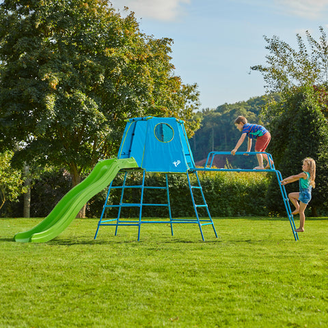 Children playing on garden metal climbing frame with slide