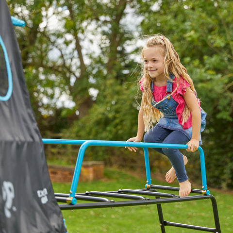 Child playing on jungle run attached to climbing frame