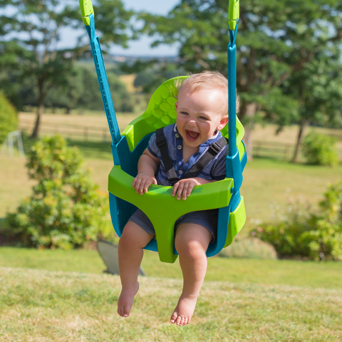 Baby swinging in a baby swing seat