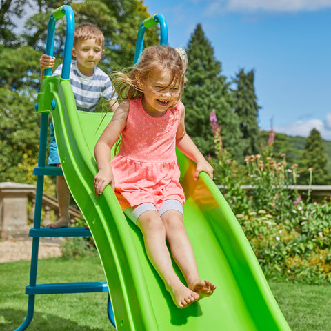 Two children playing on outdoor slide