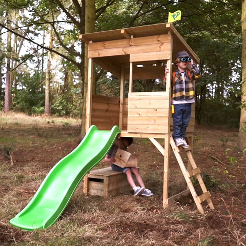 Children playing as explorers on wooden playhouse
