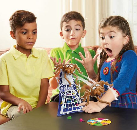 Three kids playing spider trap game