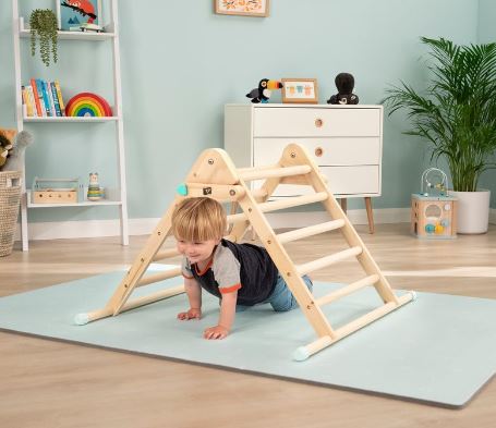 child crawling under active tots triangle