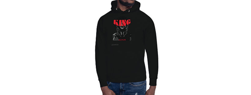 Black man wearing black God of idols hoodie with red, and shades of grey design depicting a man's face with the word "King" in red on his head like a crown.