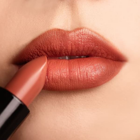 Blot your lips with a tissue to remove excess product for a more natural look