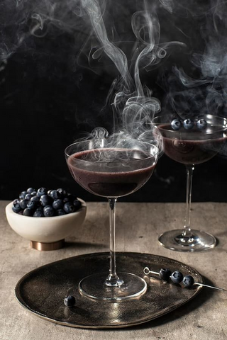 Put together a cocktail set with unique ingredients and recipes for Halloween-themed drinks.