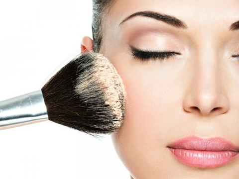 Blend and buff with a clean brush to seamlessly integrate the powder, removing excess for a flawless result