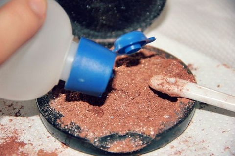 Gradually mix rubbing alcohol into the crushed blush to form a paste