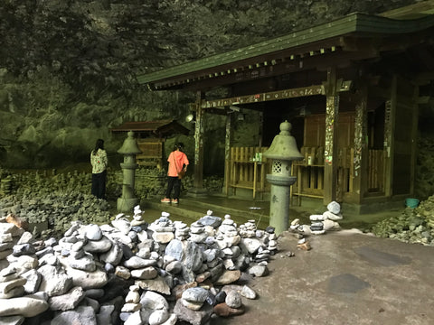 Amano Iwato Shrine in Miyazaki, Japan, with countless stacked stones inside the cave