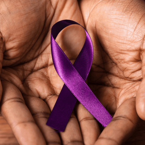 Image of hands holding a purple Alzheimer's ribbon