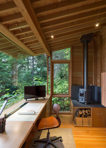 Tree house office with wooden interior and a view of the trees