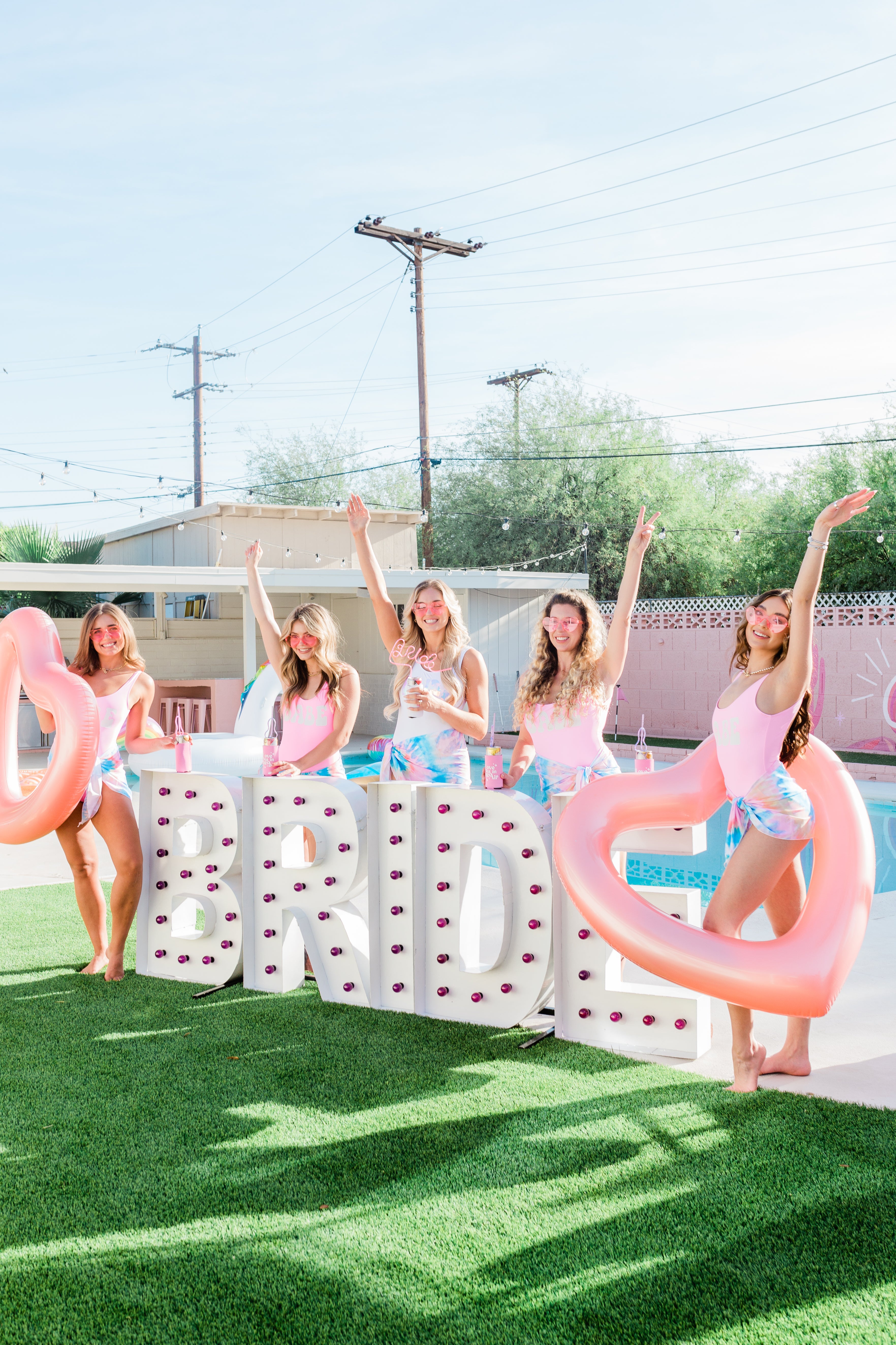 Dazed and Engaged Retro Bachelorette Party Scottsdale Arizona Groovy Bachelorette Phoenix Arizona Bachelorette Weekend Bride Bridesmaids Swimsuits Bachelorette Swim Bachelorette Bikinis Luxury picnic Pink Bounce House Bouncy Castle 