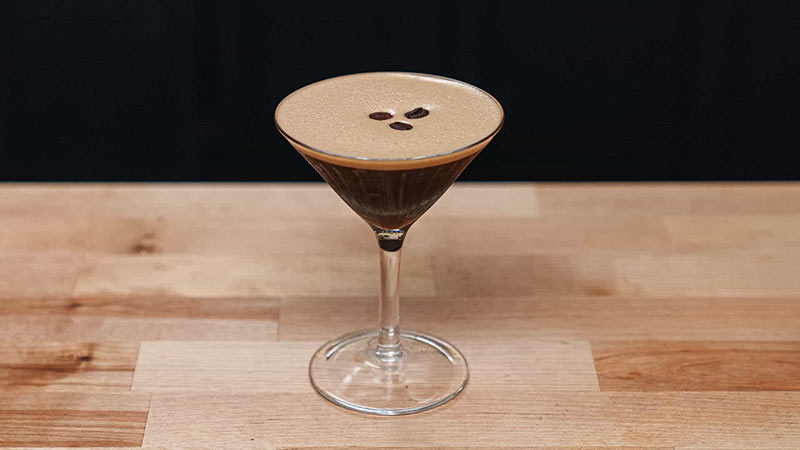 espresso martini in a cocktail glass on a wooden table 