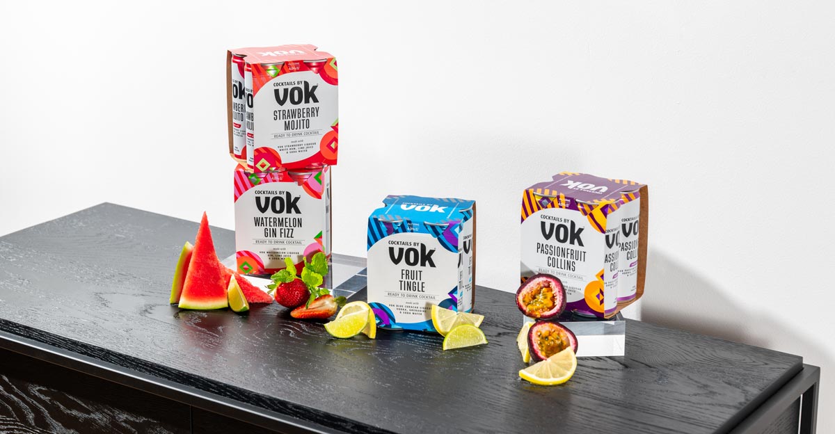 Vok RTD flavours in four packs on a black table