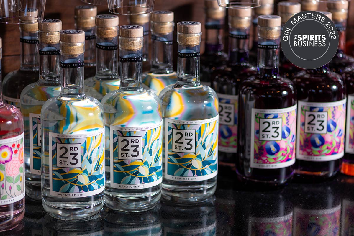 bottles of 23rd street distillery gins stacked in a rows