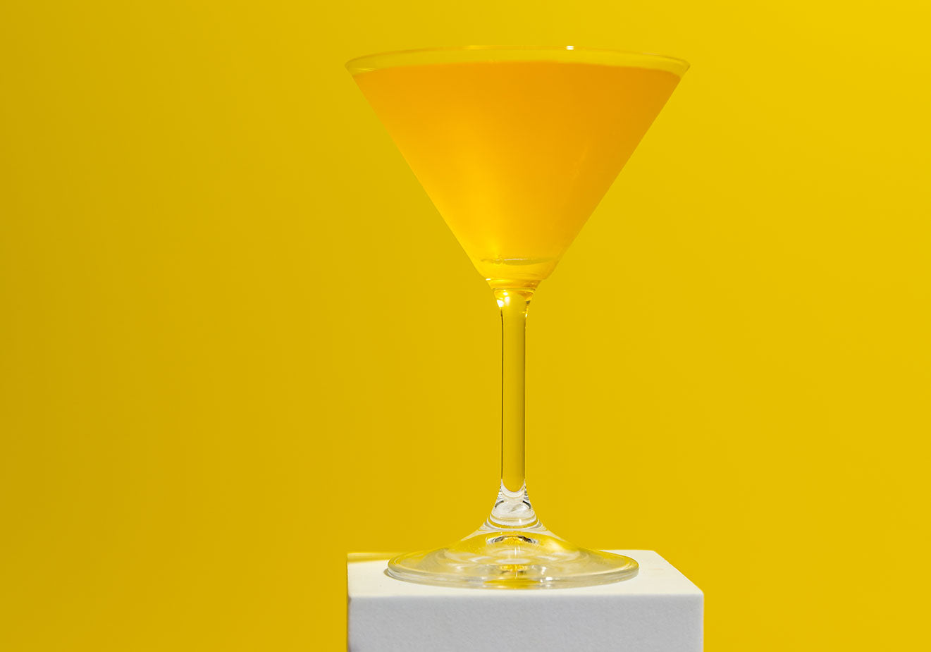 Mango daiquiri cocktail with yellow background