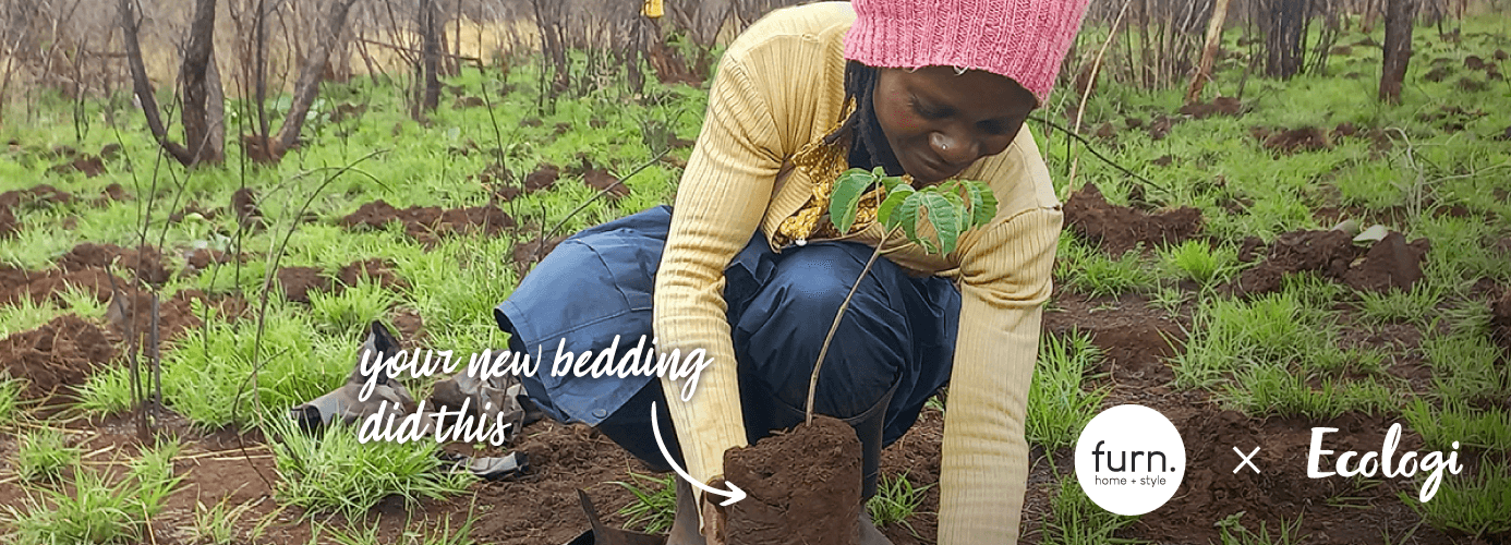 a black woman planting a tree