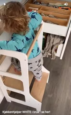 2 year old helps cover the dinner table using kitchen aids white