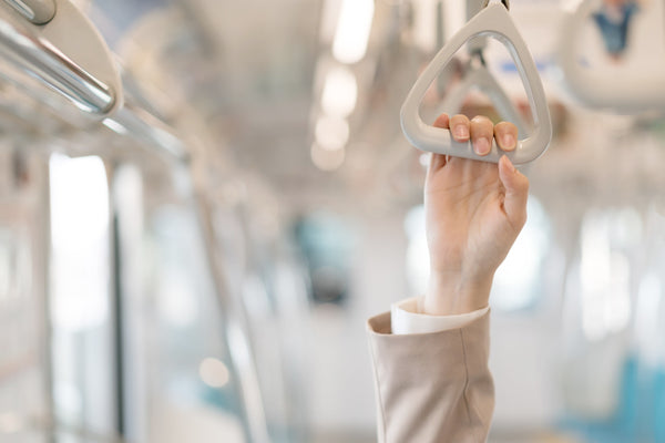 hand-holding-the-strap-while-moving-on-the-train