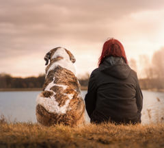 Dog Mom sitting with dog outside