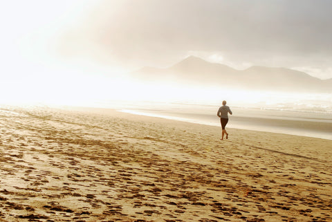 man jogging on the beach near dusk - get better sleep - WAYT nutrition.jpg