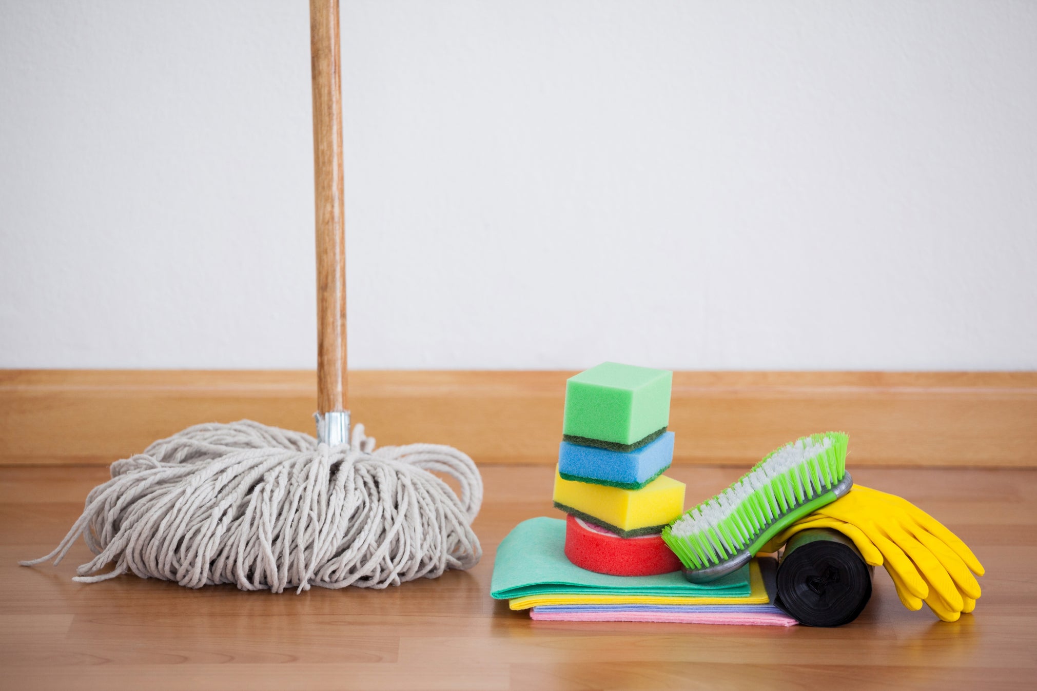 Mop and cleaning tools on wooden floor
