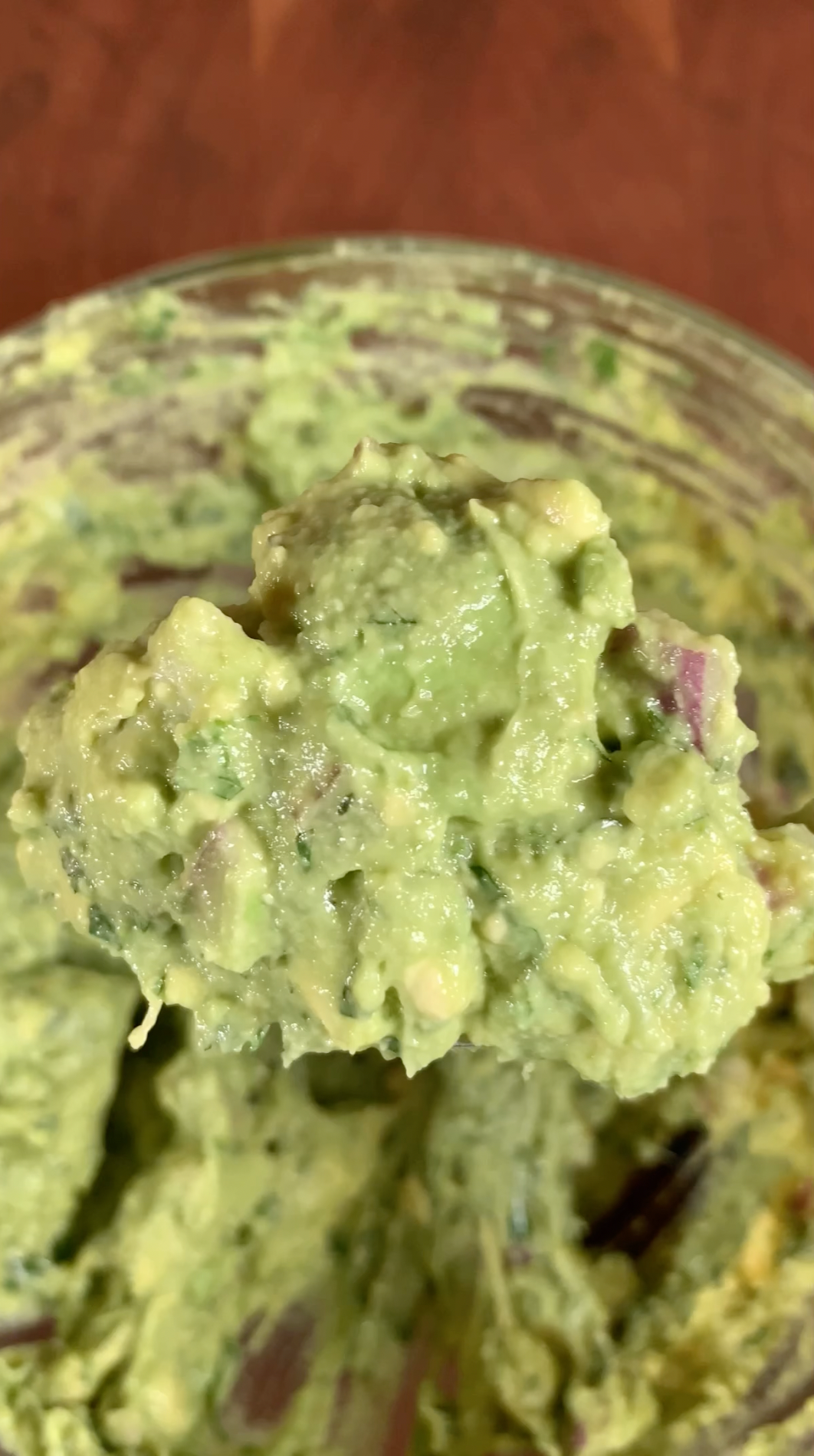 A homemade guacamole recipe with avocados, lime juice, cilantro, diced red onions, chopped jalapeños, and kosher salt. This guac will be used in a ribeye steak burrito 