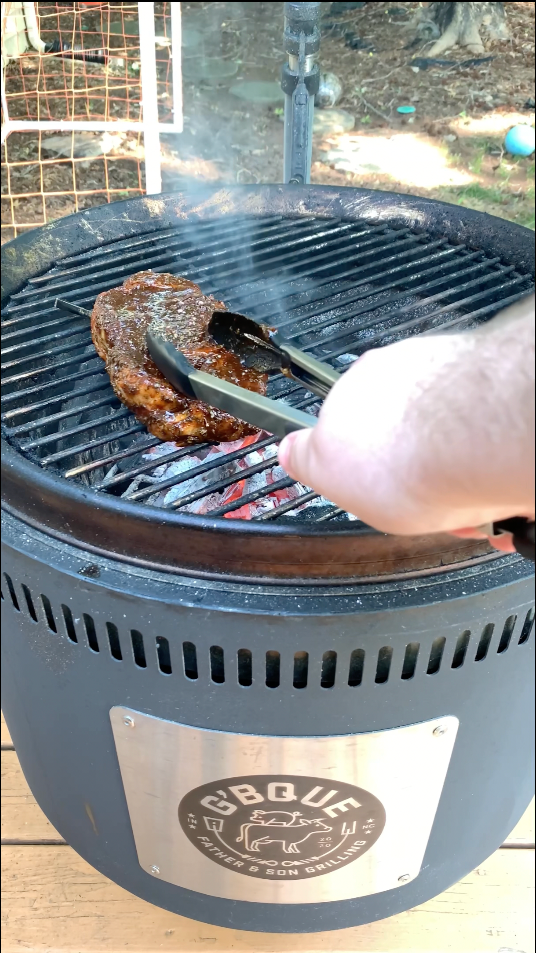 A home chef BBQ enthusiast grills a tender Certified ONYA Ribeye Rib eye steak on a Burch Barrel grill over high heat until medium rare