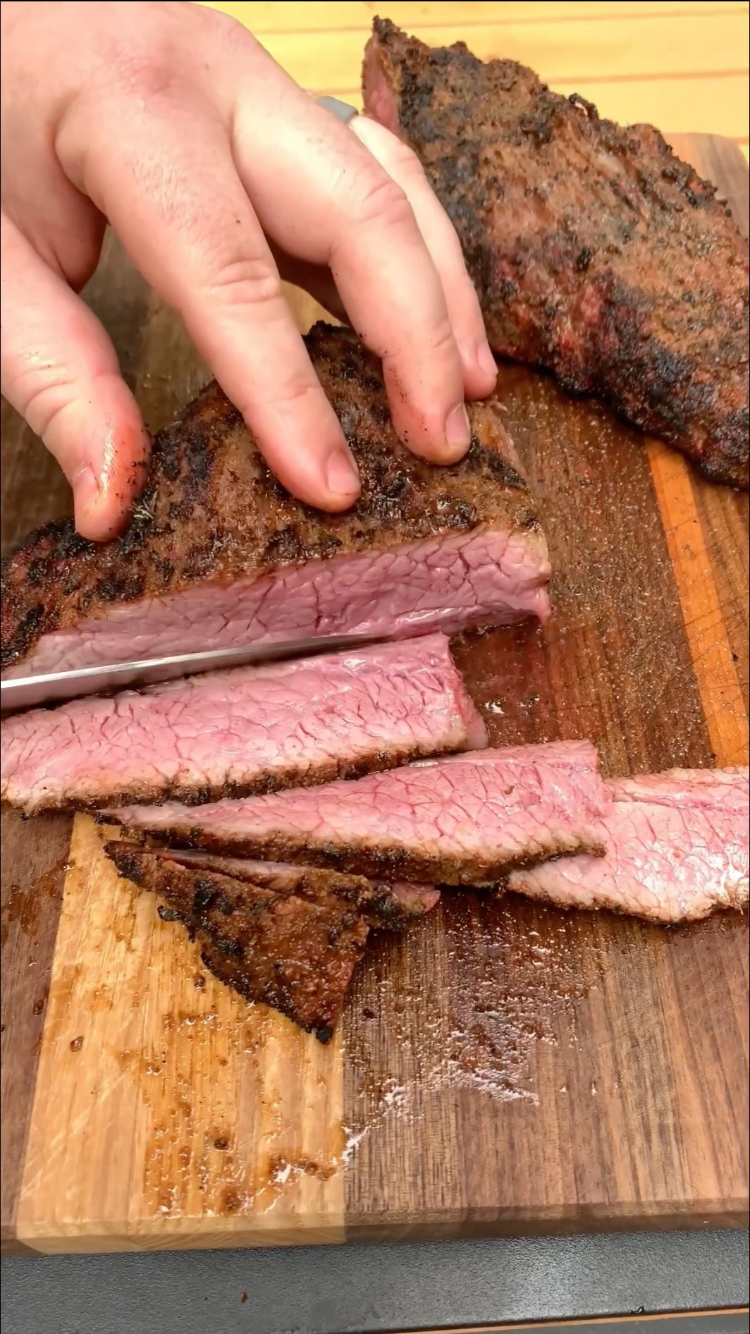 Slice a tri tip across the grain to increase the tenderness and eating experience